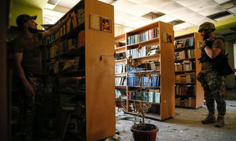 Ukrainian soldiers in the library of a damaged school in Vuhledar.