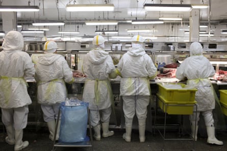 Workers process meat on a production line at the Minerva plant in Barretos.