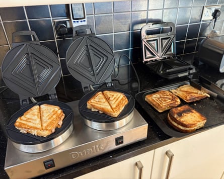 Two toastie makers on a kitchen worktop with five toasted sandwiches