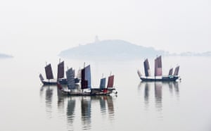 Boats rest on Lake Taihu in morning fog in Wuxi, eastern China
