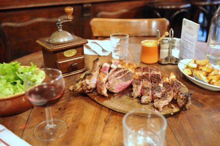 Steak, chips and lettuce on a restaurant table
