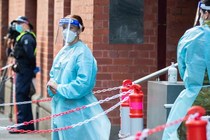 Hotel quarantine workers in PPE are seen outside the Intercontinental Hotel in Melbourne in April.