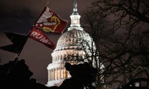 A Trump flag flies over the grounds of the US Capitol after a pro-Trump mob stormed the building earlier, breaking windows and clashing with police officers.