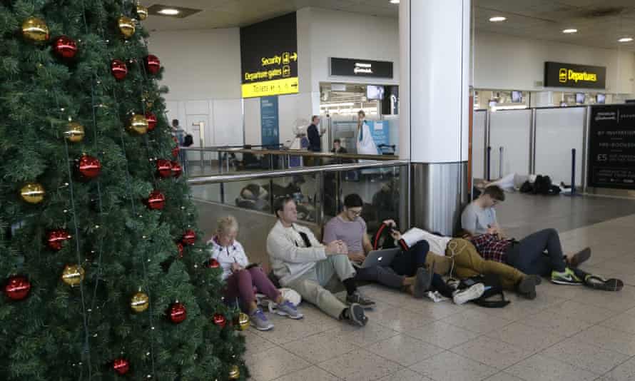 Grounded passengers wait near the departures gate at Gatwick airport on 20 December 2018.
