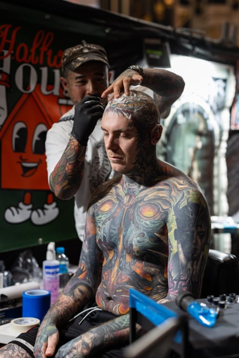 Johnie Evans tattoos the head of someone with full body and arm tattoos