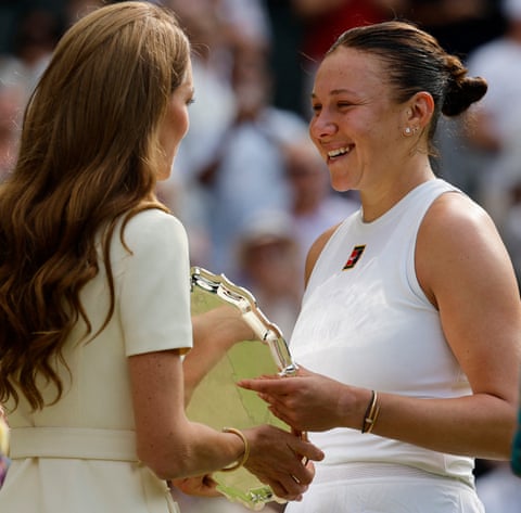 Catherine, the Princess of Wales presents a trophy to runner up Amanda Anisimova.