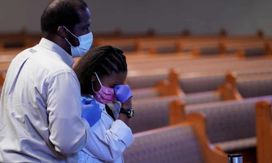 Mourners pass by the casket of George Floyd during a public visitation for Floyd at the Fountain of Praise church Monday, in Houston.