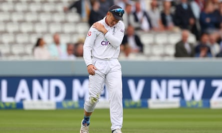 Ollie Pope holding his shoulder.