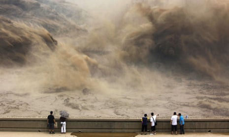 visitors gathering to giant gushes of water released from the Xiaolangdi dam to clear up the sediment-laden Yellow river and to prevent localized flooding, in Jiyuan, central China