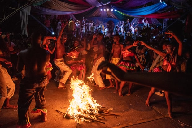 A folkloric group dances around a bonfire formed by torches in the town’s main square