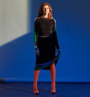 Sharon Horgan in a black dress and russet boots