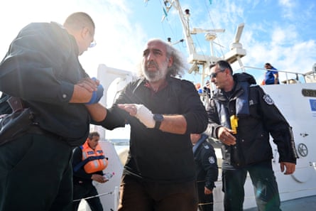 Crew members disembark from a boat.