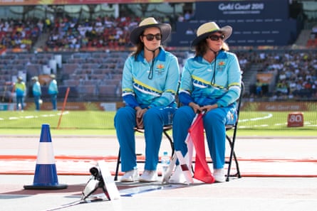 Volunteers sitting next to the long jump pit