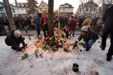People gather for a vigil after an ICE officer shot and killed a woman in Minneapolis.
