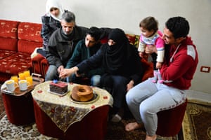 Mohammed Omran Injeela shares cake and fruit juice with his family