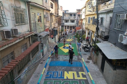 An aerial view of a street decorated with graffiti and World Cup decorations as residents of the Mare favela.