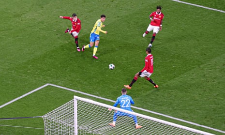 Manchester United goalkeeper Thomas Heaton saves from Brennan Johnson of Nottingham Forest.