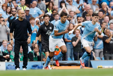 Manchester City's Rodri and Phil Foden (right) come on as substitutes as Manchester City manager Pep Guardiola (left) looks on.