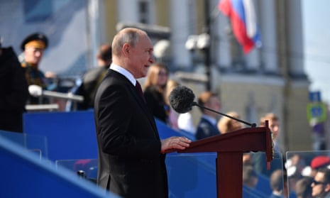Vladimir Putin gives a speech during the Navy Day parade in St Petersburg on Sunday 