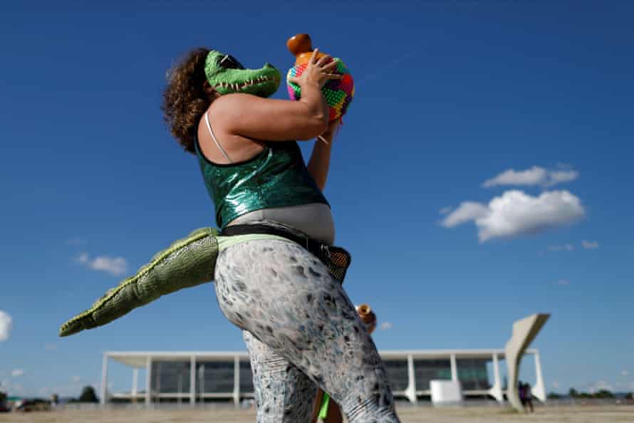 A demonstrator dressed in an alligator costume dances during a protest calling for access to the coronavirus vaccine and against Brazilian President Jair Bolsonaro.