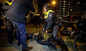 A police dog bites a demonstrator after riots broke out during a pro-Erdoğan demonstration in Rotterdam.