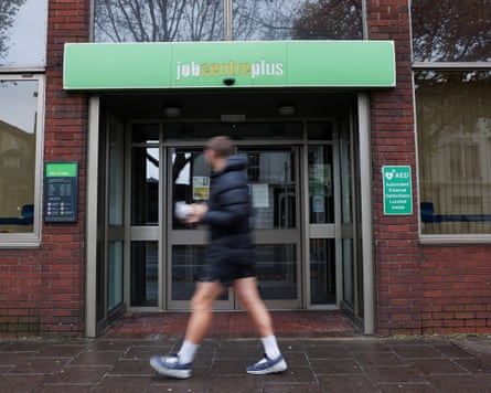 A passerby walks past a job centre in Borough, in London