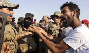 Unemployed Iraqis confront riot police during a protest to demand jobs in Basra, where anti-narcotic officers say that the use of crystal meth is doubling year on year.