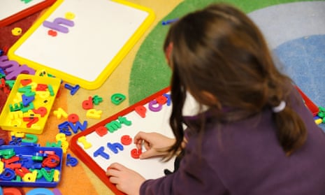 A primary school student uses magnetised letters in a classroom