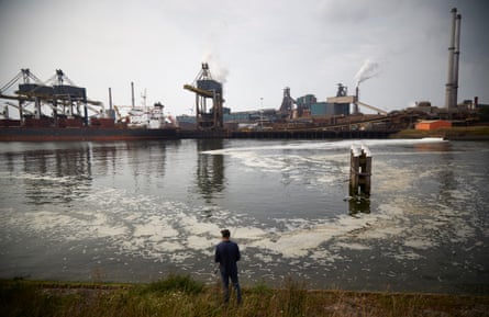 A man fishes near a steel plant in IJmuiden, in the Netherlands.
