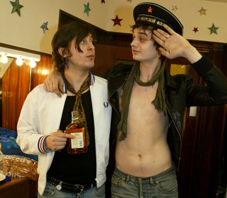 Carl Barat and Pete Doherty backstage, looking into each other’s eyes, drinking, Doherty saluting in a Russian military hat