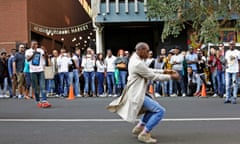 A man performs a street dance in front of crowds in Braamfontein, Johannesburg, South Africa