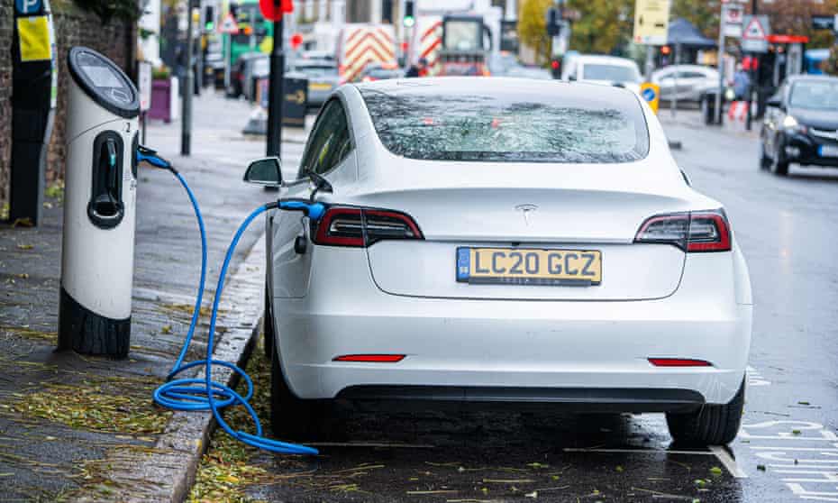 A Tesla car plugged to an electric charging station in Wimbledon, south London