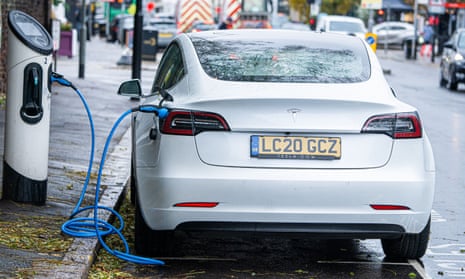 A Tesla car plugged into a charging station in Wimbledon, south-west London