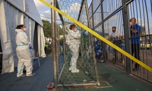 Israeli healthcare workers speak with a man who wants to test himself for the coronavirus at a testing centre for migrants in Tel Aviv, Israel, 6 July 2020.