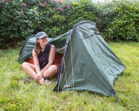 Sian Lewis sits smiling in front of the Easy Camp Sarek 2 tent
