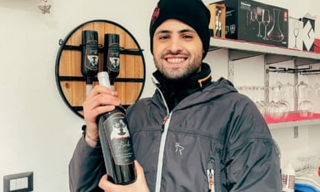 Winemaker Mattia Muggittu with a bottle of his Boeli wine