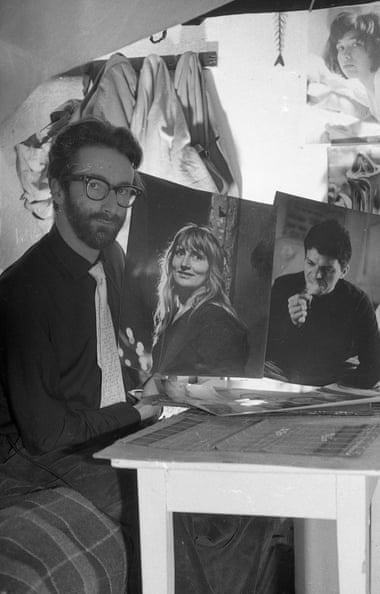 Harold Chapman holding two of his photographs