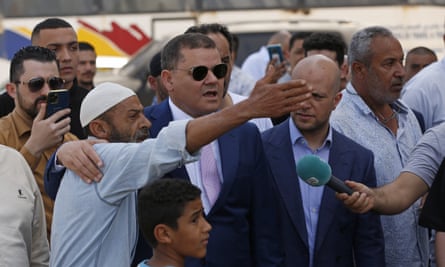 Abdul Hamid Dbeibah, centre, visits a Tripoli neighbourhood following the clashes.