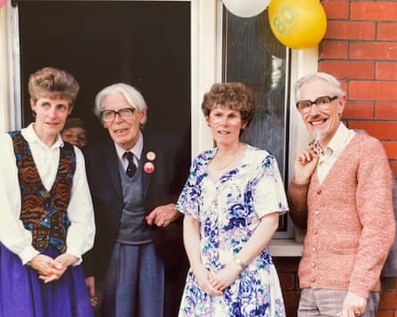 Four people pose for a picture in the garden during an 80th birthday party