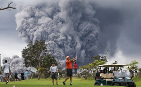 Golfers ignore an erupting volcano, Hawaii