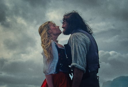 Jacob Elordi and Margot Robbie against a cloudy background in Wuthering Heights