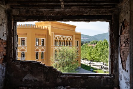 A newly restored building viewed from a crumbling one across the street. Despite 30 years of peace and an influx of tourists, many of the buildings in Mostar are still in ruins