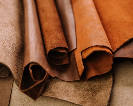 A selection of rolls of leather in shades of brown.