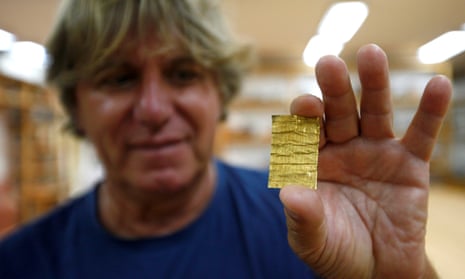 Chief archaeologist Miomir Korać displays one of the gold rolls