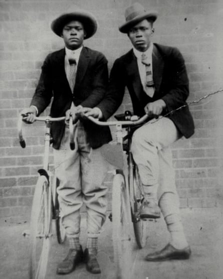 Two black South African men pose proudly with their bicycles in 1922.