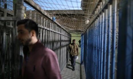Palestinians cross through Israeli checkpoint to get to work.