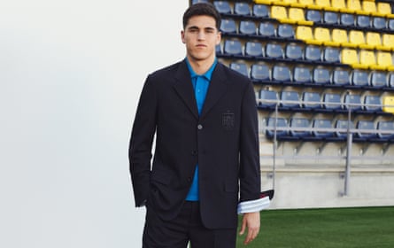 Cubarsi in black suit with bright blue polo-style shirt underneath