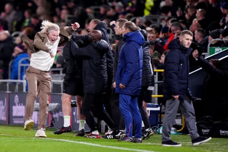 Robbie Savage celebrates in front of Jack Wilshere.