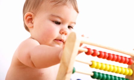 A baby playing with an abacus