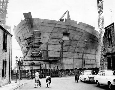 A supertanker seen at the end of a terraced street.